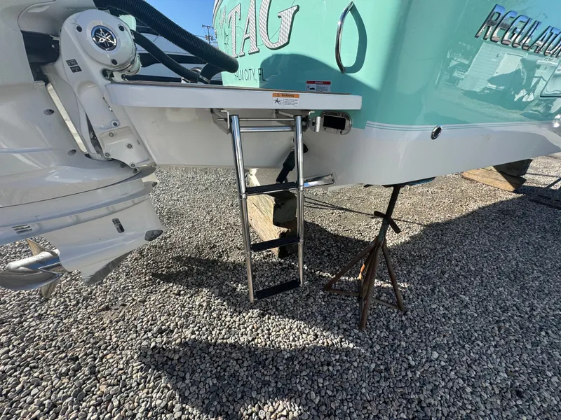Slide: The Image of 2022 Regulator 31 boat with ladder and outboard motor. - 7