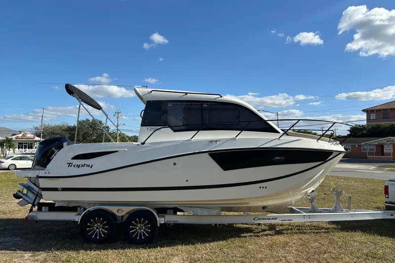 The Image of 2026 Trophy T 25 Explorer boat on trailer under blue sky. - 0