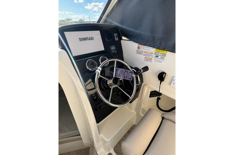 Slide: The Image of 2026 Trophy T 25 Explorer boat dashboard with steering wheel and Simrad display. - 10