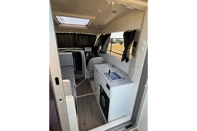 Slide: The Image of Interior of 2026 Trophy T 25 Explorer boat with kitchenette and seating area. - 15