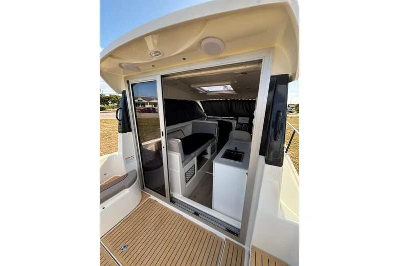 Slide: The Image of 2026 Trophy T 25 Explorer boat interior with sliding door and seating area. - 17