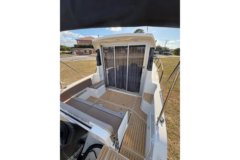 Slide: The Image of 2026 Trophy T 25 Explorer boat deck with seating and sliding glass doors. - 4