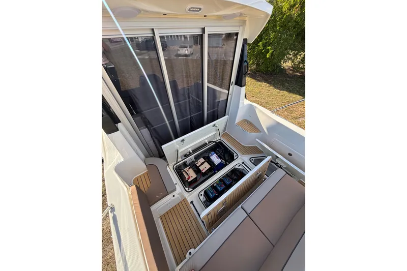 Slide: The Image of 2026 Trophy T 25 Explorer boat interior with open storage compartments and seating. - 6
