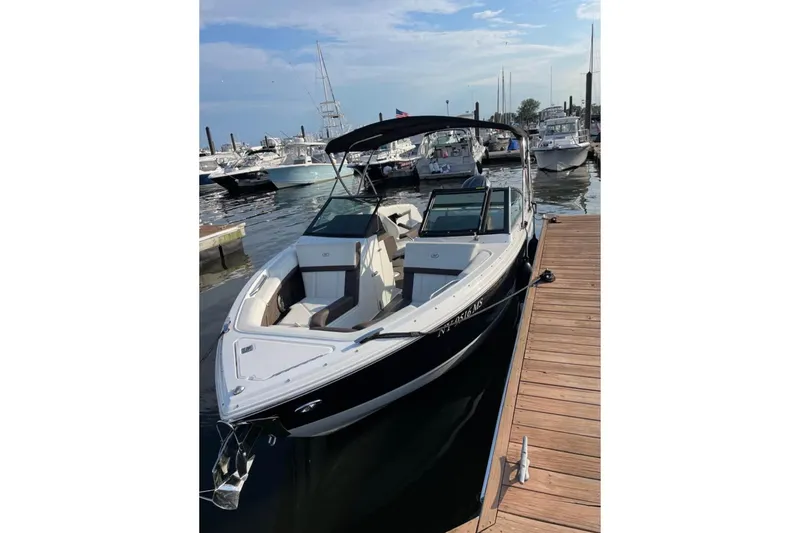 The Image of 2022 Cobalt R4 Outboard boat docked at marina, clear sky, calm water. - 1