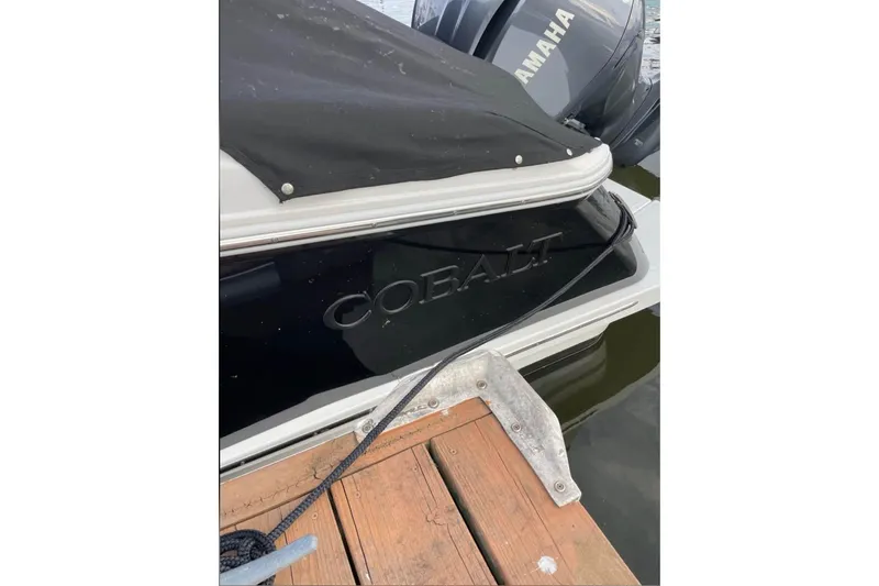 Slide: The Image of 2022 Cobalt R4 Outboard boat docked with Yamaha engine visible. - 11