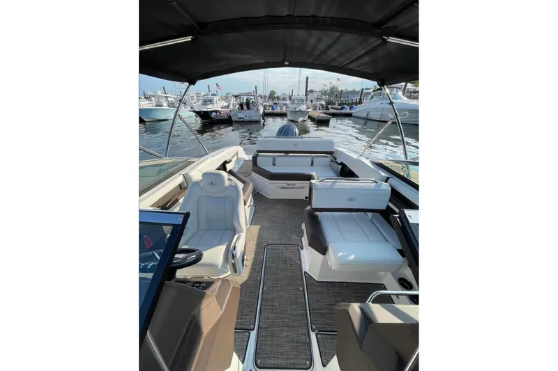 Slide: The Image of 2022 Cobalt R4 Outboard boat interior with seating, docked at marina. - 3