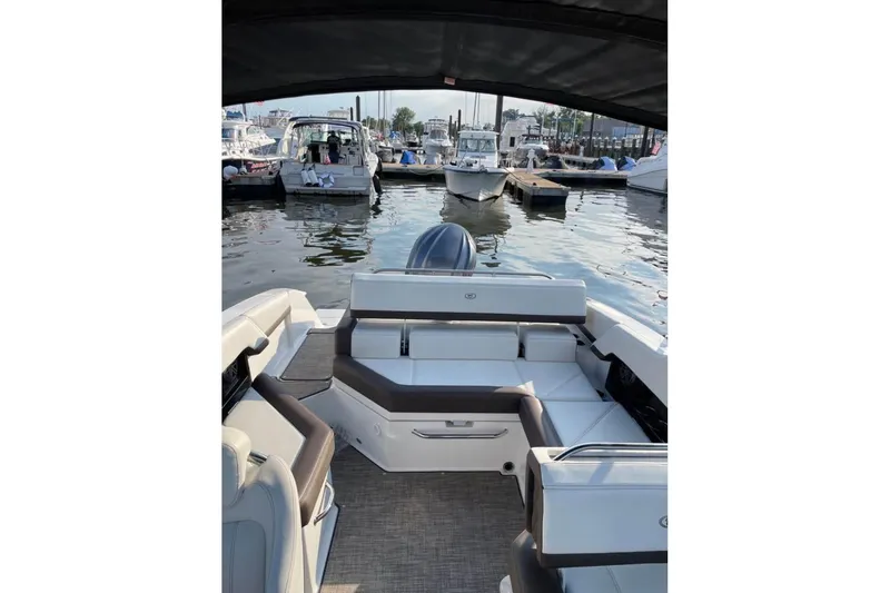 Slide: The Image of 2022 Cobalt R4 Outboard boat interior at marina, featuring spacious seating and modern design. - 4