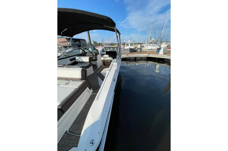 Slide: The Image of 2022 Cobalt R4 Outboard boat docked at marina under clear blue sky. - 8