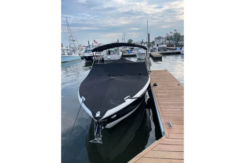 Slide: The Image of 2022 Cobalt R4 Outboard boat docked at marina under cloudy sky. - 9