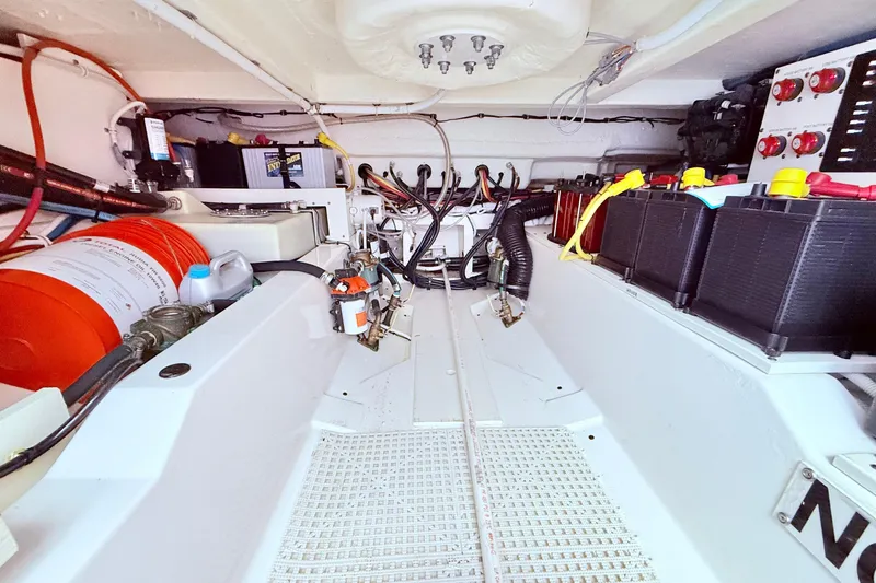 Slide: The Image of Engine compartment of 2022 Tiara Yachts 38 LS, showcasing batteries and wiring. - 14