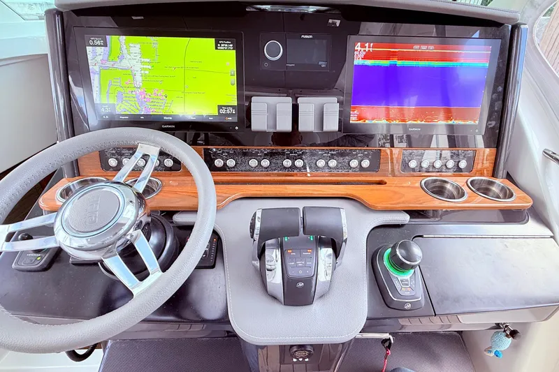 Slide: The Image of 2022 Tiara Yachts 38 LS dashboard with navigation screens and controls. - 7