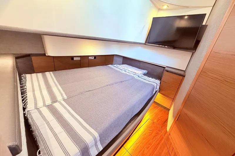 Slide: The Image of Luxurious cabin interior of 2022 Tiara Yachts 38 LS with cozy bed and TV. - 9