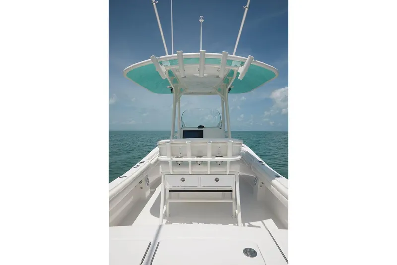 Slide: The Image of 2019 Regulator 25 boat interior with open storage compartment and clean white deck. - 14