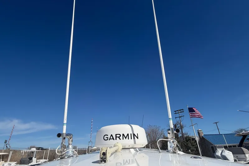 Slide: The Image of 2019 Regulator 25 boat with cushioned seating, docked by the water. - 30