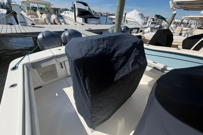 Slide: The Image of 2019 Regulator 25 boat interior with white seating and docked at marina. - 35