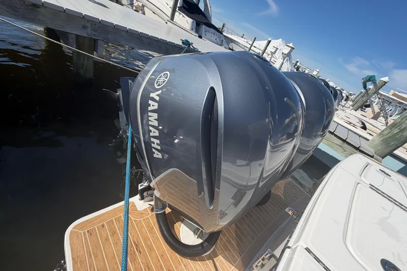 Slide: The Image of 2019 Regulator 25 boat deck with storage compartment and rope. - 38