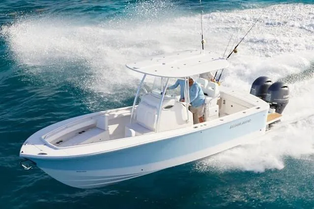 Slide: The Image of 2019 Regulator 25 boat on water, featuring sleek design and dual Yamaha engines. - 4