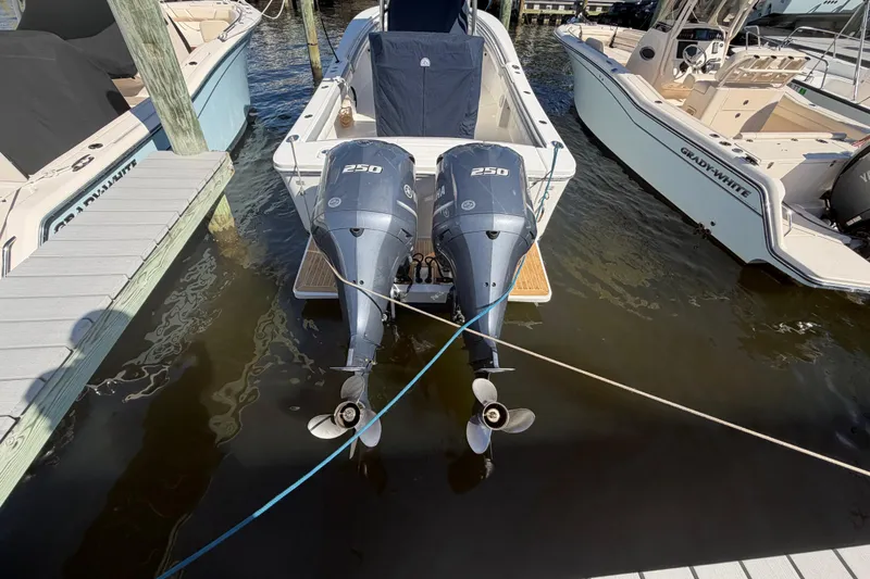 Slide: The Image of 2019 Regulator 25 boat with rod holders against clear blue sky. - 40