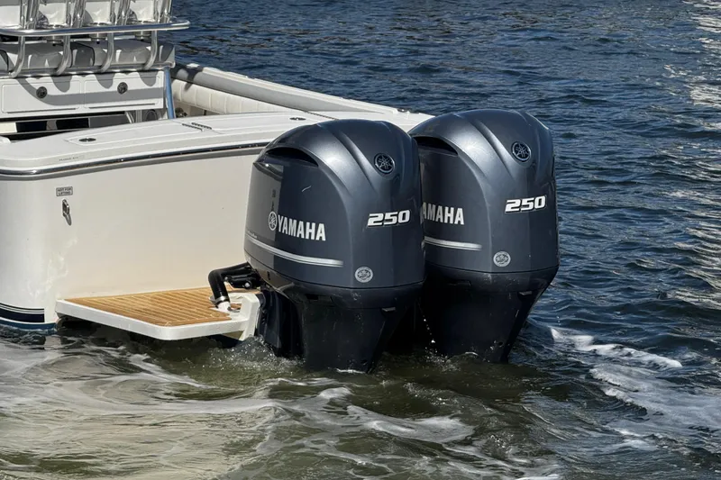 Slide: The Image of 2019 Regulator 25 boat with stainless steel T-top frame near a bridge on a sunny day. - 43