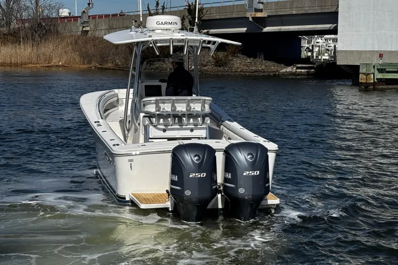 Slide: The Image of 2019 Regulator 25 boat navigating under a bridge on a sunny day. - 44