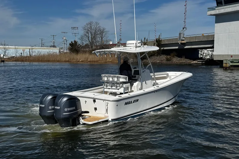 Slide: The Image of 2019 Regulator 25 boat console covered at marina dock. - 47