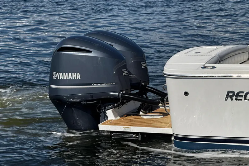 Slide: The Image of Twin Yamaha outboard engines on a 2019 Regulator 25 boat at a dock. - 48