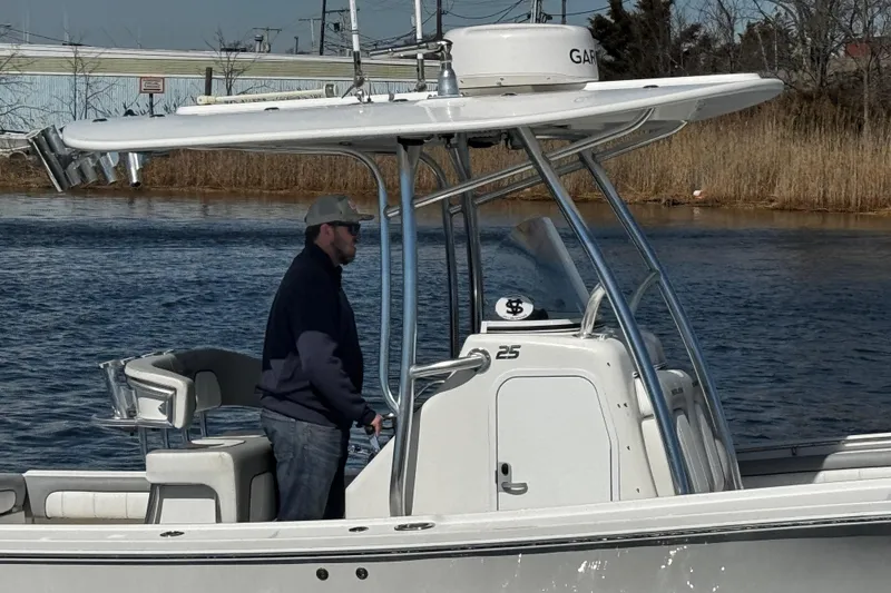 Slide: The Image of Twin Yamaha outboard engines on a 2019 Regulator 25 boat docked at a marina. - 49