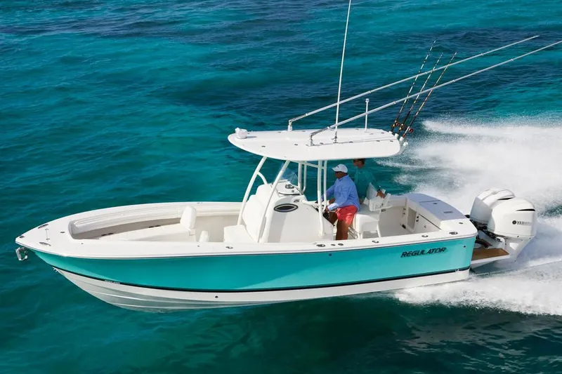 Slide: The Image of 2019 Regulator 25 boat on water, featuring dual Yamaha engines and Garmin equipment. - 5