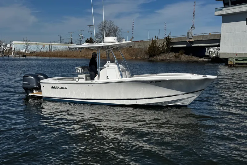 Slide: The Image of Twin Yamaha outboard engines on a 2019 Regulator 25 boat at a dock. - 50