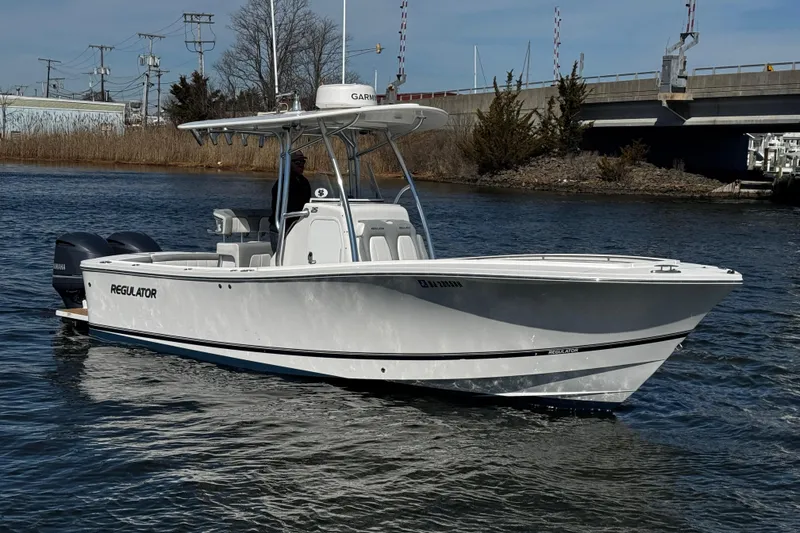 Slide: The Image of 2019 Regulator 25 boat with twin Yamaha 250 engines docked at marina. - 51