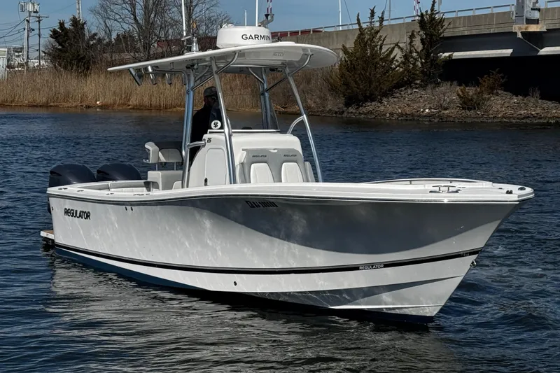 Slide: The Image of 2019 Regulator 25 boat with twin Yamaha 250 outboard engines on water. - 53