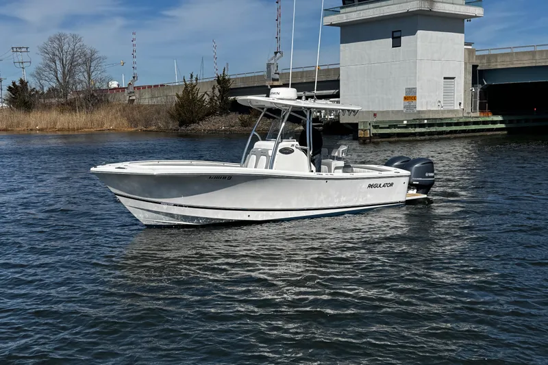Slide: The Image of 2019 Regulator 25 boat interior with cushioned seating and sleek design. - 58