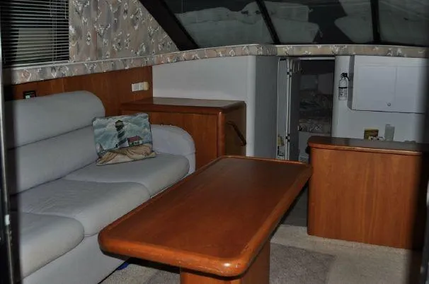 Slide: The Image of Interior of a 1993 Silverton 37 Convertible yacht with sofa and table. - 13