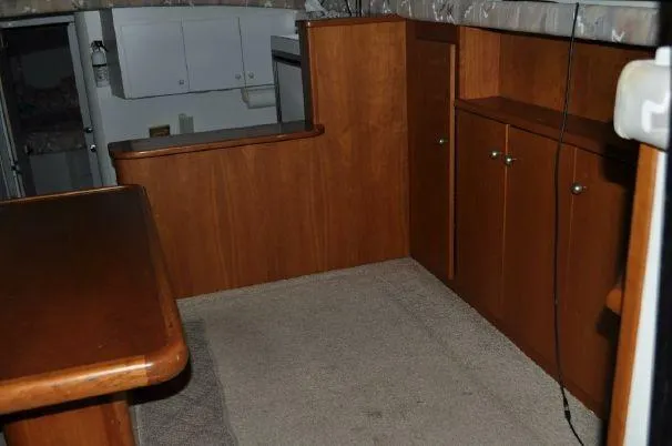 Slide: The Image of 1993 Silverton 37 Convertible yacht interior with wooden cabinetry. - 14