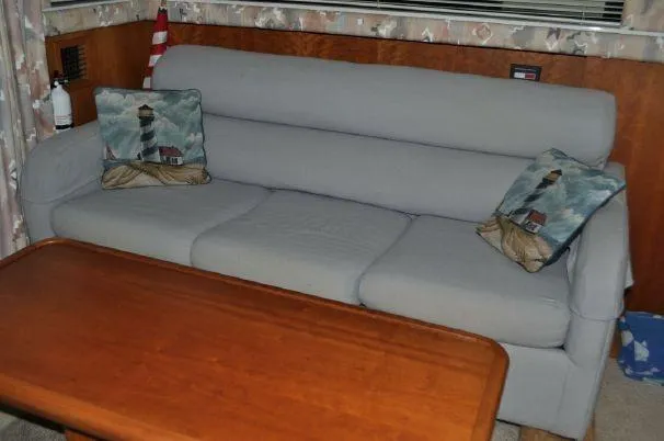 Slide: The Image of Interior of 1993 Silverton 37 Convertible with gray sofa and wooden table. - 16