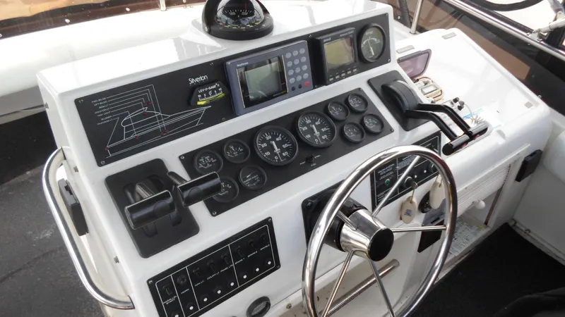 Slide: The Image of 1993 Silverton 37 Convertible helm with navigation instruments. - 3