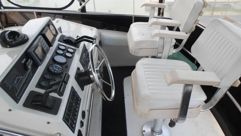 Slide: The Image of 1993 Silverton 37 Convertible boat cockpit with steering wheel and controls. - 5