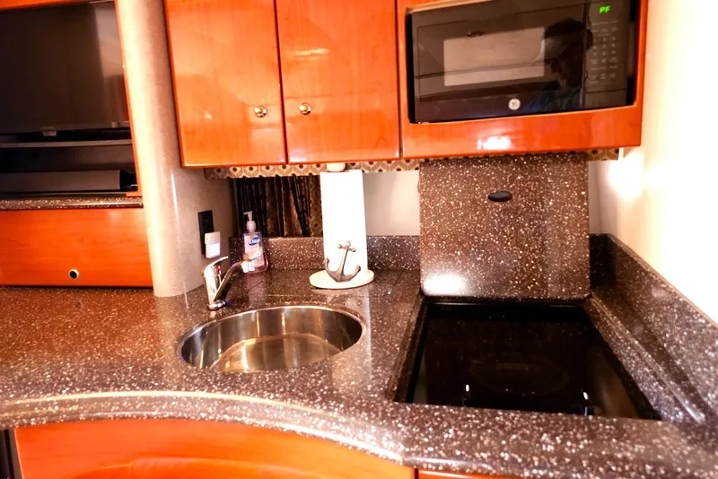 Slide: The Image of 2004 Formula 40 Performance Cruiser kitchen with sink, microwave, and sleek countertops. - 14