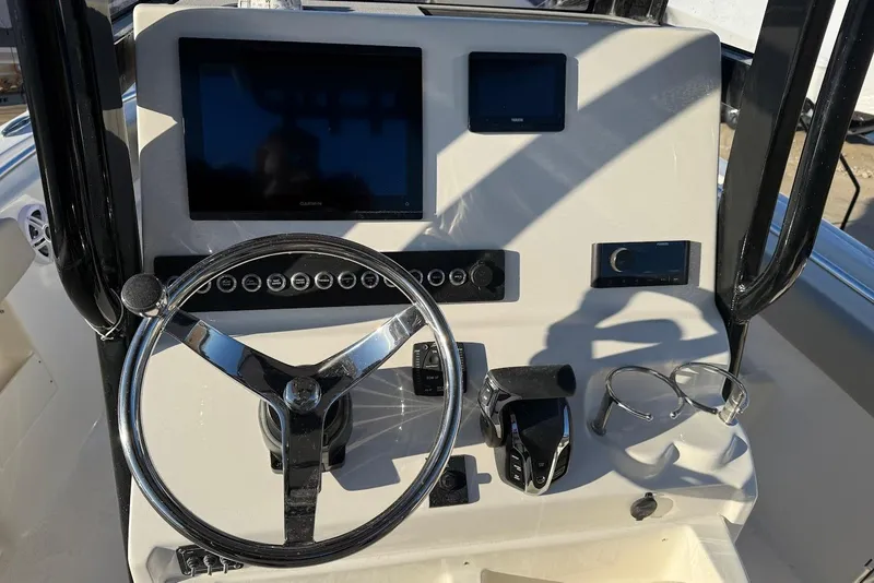 Slide: The Image of 2026 Key West 239 FS boat dashboard with steering wheel and electronic controls. - 14
