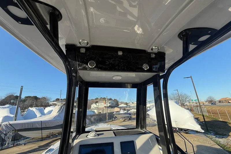 Slide: The Image of 2026 Key West 239 FS boat interior view with console and overhead structure. - 15