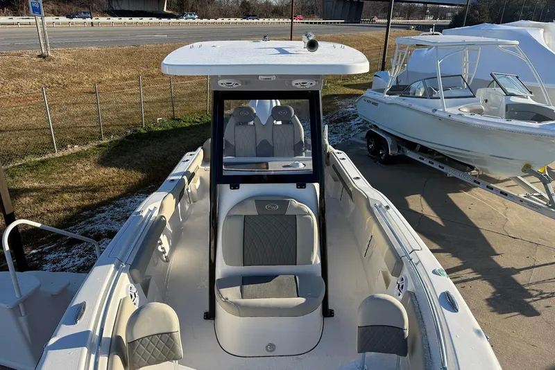 Slide: The Image of 2026 Key West 239 FS boat with seating, parked near highway. - 16