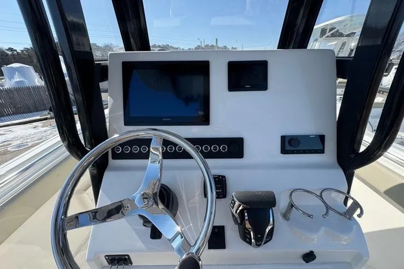 Slide: The Image of 2026 Key West 239 FS boat dashboard with steering wheel and electronic displays. - 18