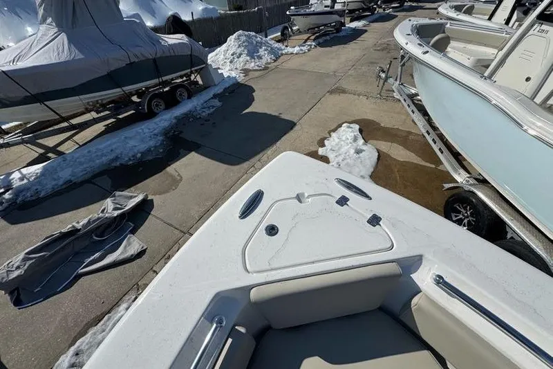 Slide: The Image of 2026 Key West 239 FS boat in snowy outdoor storage, partially covered. - 20