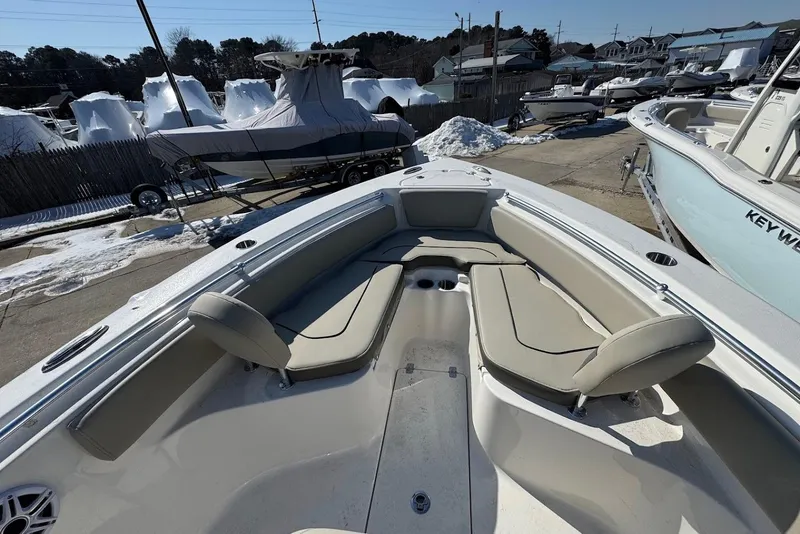 Slide: The Image of 2026 Key West 239 FS boat with beige seating, docked in a snowy marina. - 21
