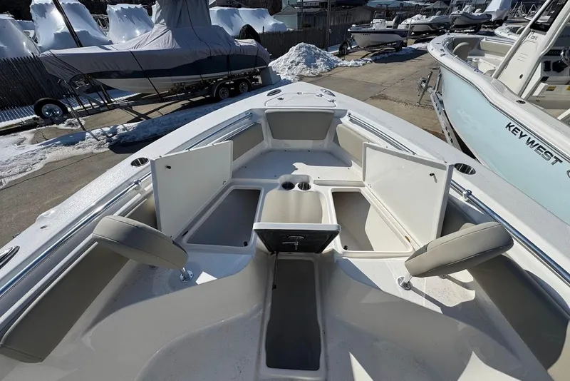 Slide: The Image of 2026 Key West 239 FS boat interior with open storage compartments and seating. - 22