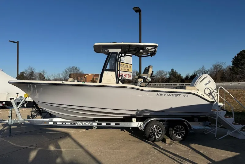 The Image of 2026 Key West 239 FS boat on trailer, parked outdoors under clear blue sky. - 6