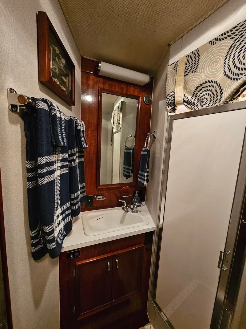 Slide: The Image of Interior of 1975 Hatteras 58L Long Range Cruiser with green sofas. - 33