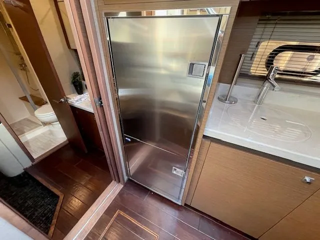 Slide: The Image of 2016 Sea Ray 510 DA yacht with sleek design and blue sky. - 38