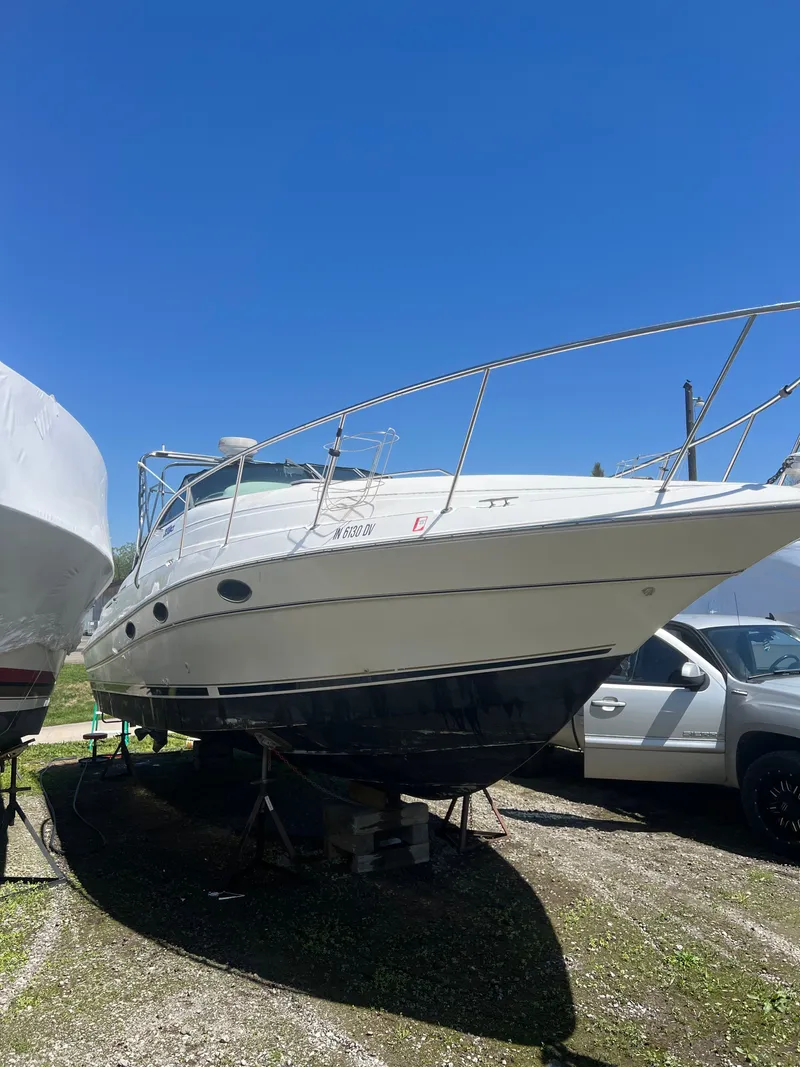 Slide: The Image of 1999 Doral 300 SC boat on a trailer outdoors. - 2