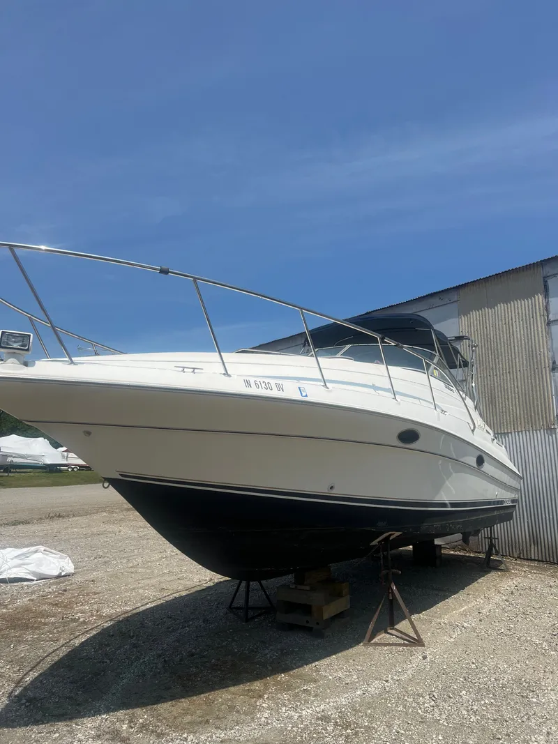 Slide: The Image of 1999 Doral 300 SC boat on stands outdoors. - 3